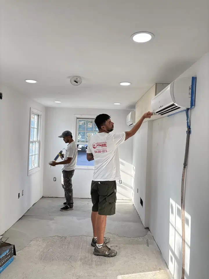 Two Hyannis Painting crew members working in a commercial space