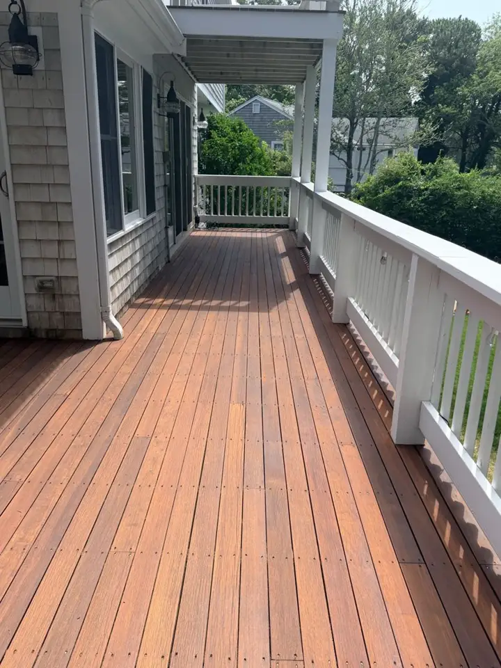 Freshly stained deck boards with white railing
