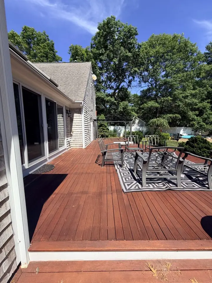 Stained deck with outdoor seating and blue sky