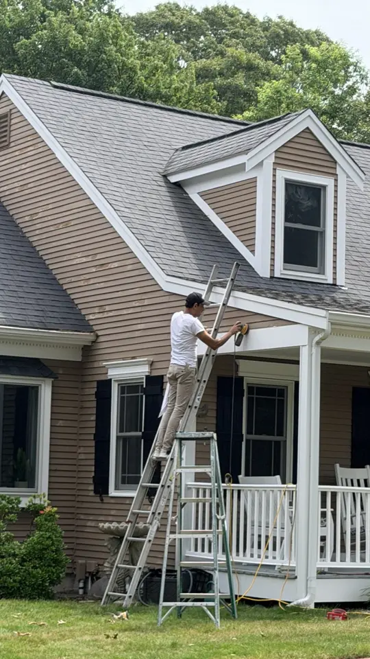 Painter on a ladder at a Cape Cod home