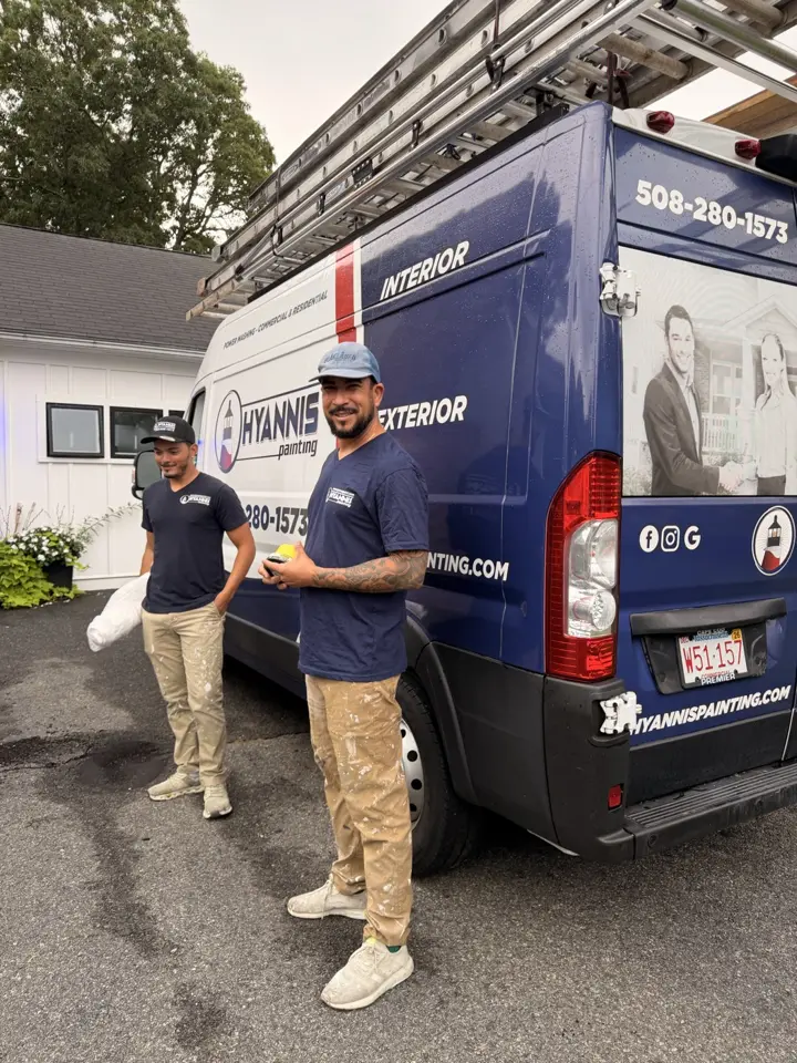 Two Hyannis Painting team members beside the van