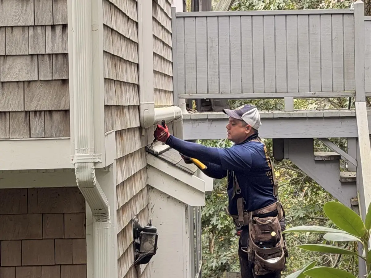 Hyannis Painting carpenter repairing exterior trim on a Cape Cod home