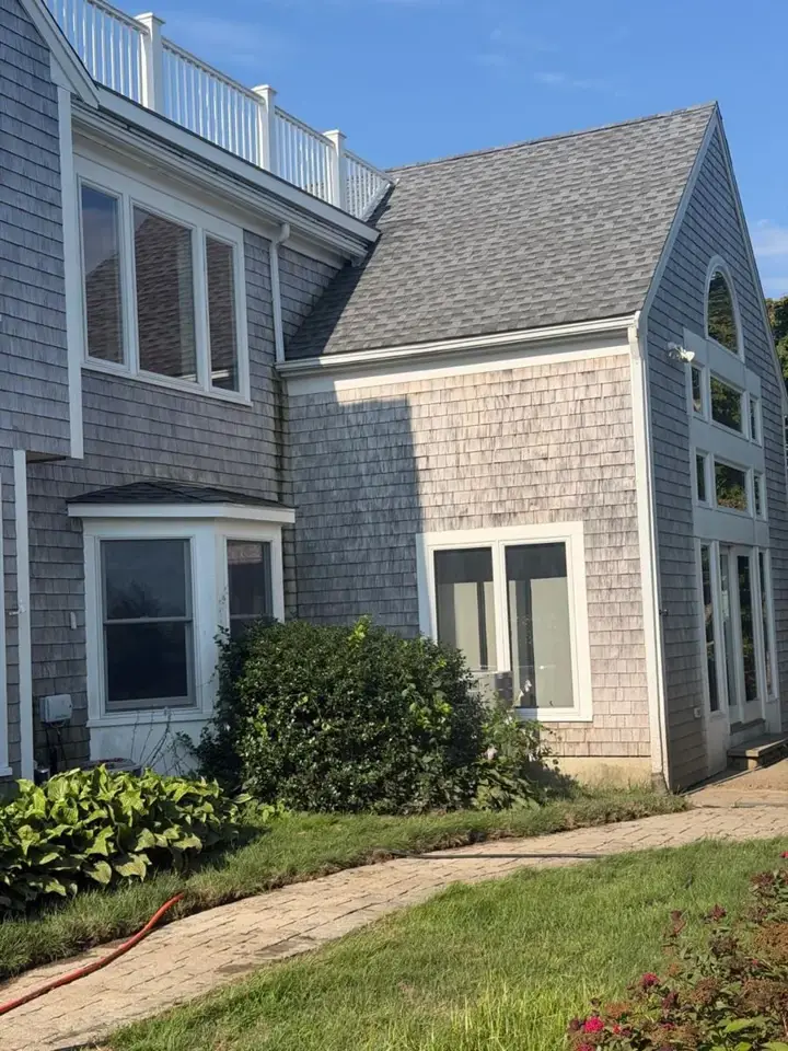 Cape Cod home with cedar shingle siding, washed and ready for paint