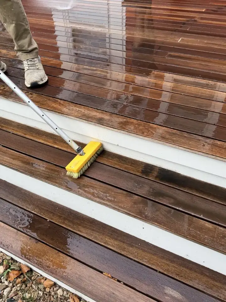 Brush washing a wood deck on Cape Cod